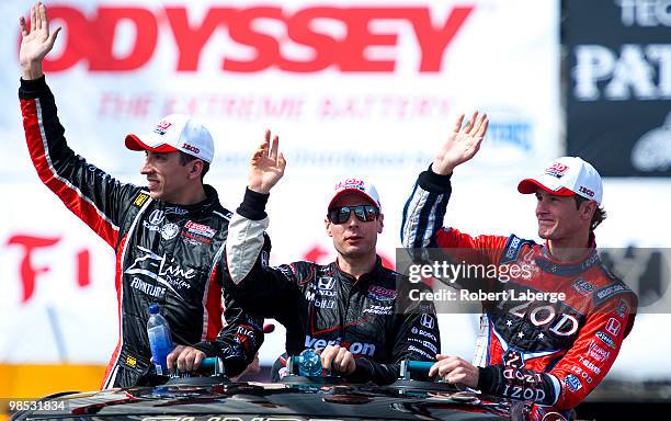 Justin Wilson of England Will Power of Australia and Ryan Hunter-Reay take a lap of honur and wave at the crowd during the IndyCar Series Toyota...