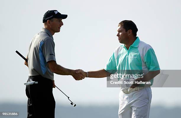 Jim Furyk shakes hands with Brian Davis of England on the 18th green during the final round of the Verizon Heritage at the Harbour Town Golf Links on...