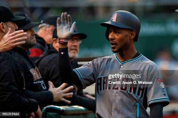 Jarrod Dyson of the Arizona Diamondbacks is congratulated by teammates after scoring a run against the Oakland Athletics during the fourth inning at...