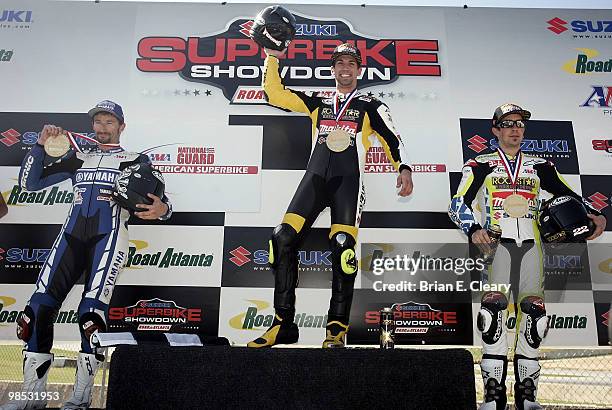 Podium finishers, left to right, Josh Hayes, Blake Young, and Tommy Hayden celebrate after the Sunday American Superbike race during the AMA...