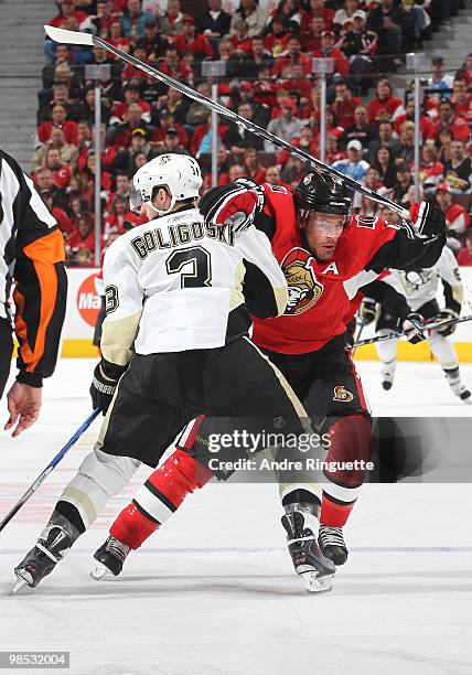 Mike Fisher of the Ottawa Senators forces his way past Alex Goligoski of the Pittsburgh Penguins in Game Three of the Eastern Conference...