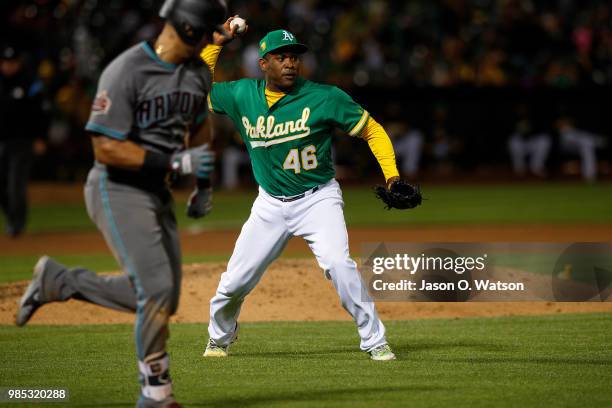 Santiago Casilla of the Oakland Athletics throws to first base after fielding a ground ball hit off the bat of David Peralta of the Arizona...