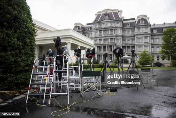 Television cameras stand outside the West Wing of the White House in Washington, D.C., U.S., on Wednesday, June 27, 2018. Kudlow said the U.S. Is...