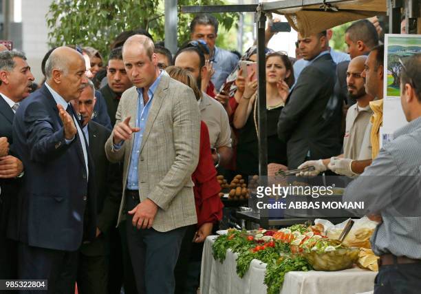 Britain's Prince William meets with Jibril Rajoub , the head of the Palestinian Football Association, at a reception during his visit to the Ramallah...