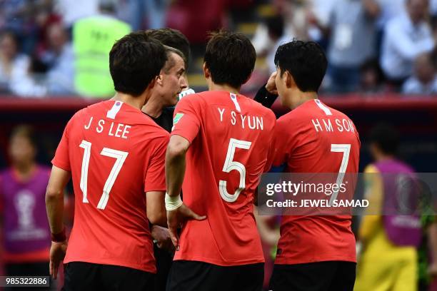 South Korea's midfielder Lee Jae-sung, South Korea's defender Yun Young-sun and South Korea's forward Son Heung-min argue with US referee Mark Geiger...