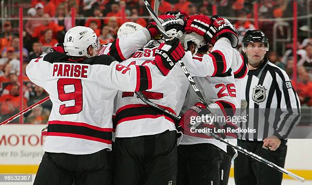 Brian Rolston of the New Jersey Devils is mobbed by teammates Zach Parise, Ilya Kovalchuk, and Patrick Elias after scoring a second period power-play...