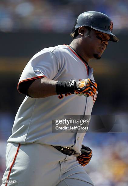 Juan Uribe of the San Francisco Giants rounds first base after hitting a solo homerun in the seventh inning against the Los Angeles Dodgers at Dodger...