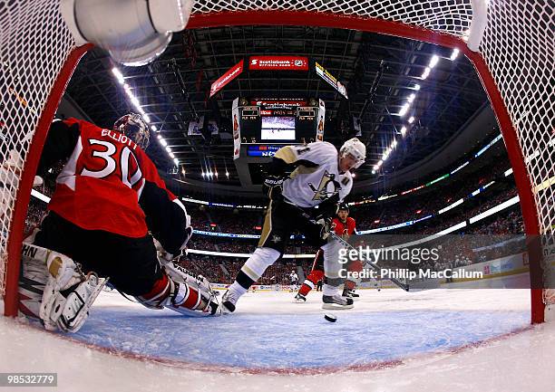Evgeni Malkin of the Pittsburgh Penguins picks up a loose puck in front of an open net before scoring a goal on Brian Elliott of the Ottawa Senators...