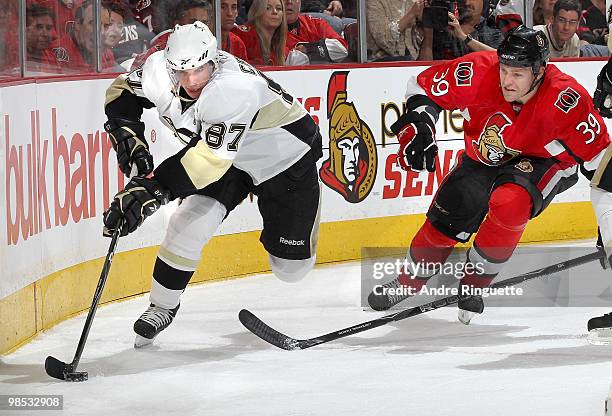 Matt Carkner of the Ottawa Senators chases Sidney Crosby of the Pittsburgh Penguins along the boards in Game Three of the Eastern Conference...