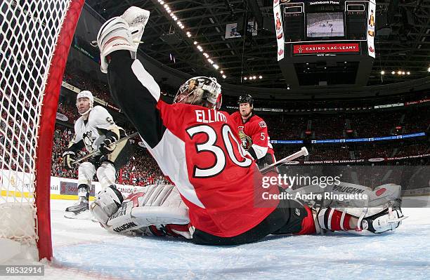 Brian Elliott of the Ottawa Senators makes a glove save in front of Pascal Dupuis of the Pittsburgh Penguins in Game Three of the Eastern Conference...