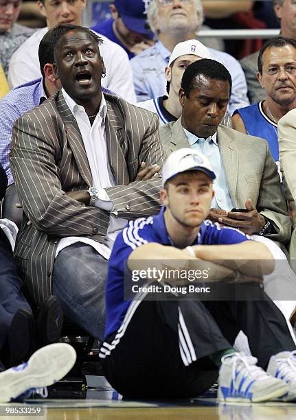 Owner Michael Jordan of the Charlotte Bobcats sits next to former NFL player Ahmad Rashad while watching his team take on the Orlando Magic in Game...