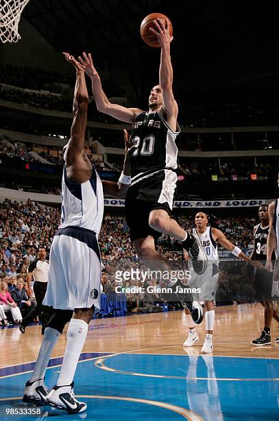 Manu Ginobili of the San Antonio Spurs goes in for the layup against Erick Dampier of the Dallas Mavericks in Game One of the Western Conference...