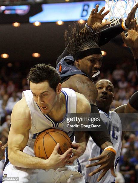 Gerald Wallace of the Charlotte Bobcats has a rebound taken away from him by J.J. Redick of the Orlando Magic in Game One of the Eastern Conference...