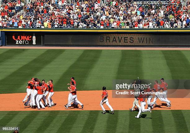 Jason Heyward of the Atlanta Braves is congratulated by teammates after knocking in the game-winning runs against the Colorado Rockies at Turner...