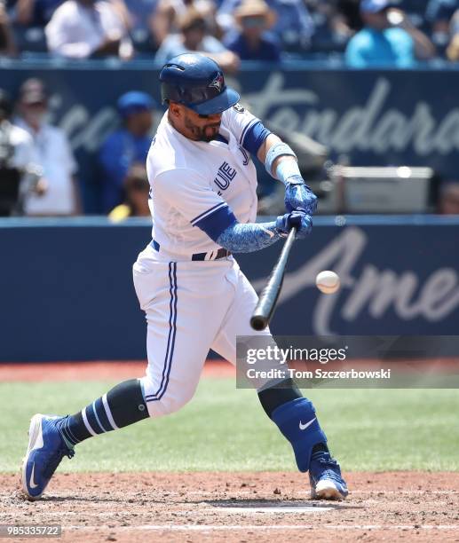 Devon Travis of the Toronto Blue Jays hits a single in the fourth inning during MLB game action against the Washington Nationals at Rogers Centre on...