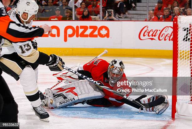 Bill Guerin of the Pittsburgh Penguins slides the puck past a sprawling Brian Elliott of the Ottawa Senators for a goal during Game 3 of the Eastern...