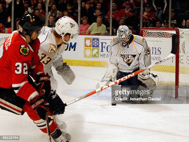 Pekka Rinne of the Nashville Predators stops a shot by Kris Versteeg of the Chicago Blackhawks as teammate Colin Wilson defends in Game Two of the...