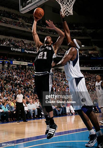 Tim Duncan of the San Antonio Spurs goes up for the layup against Brendan Haywood of the Dallas Mavericks in Game One of the Western Conference...