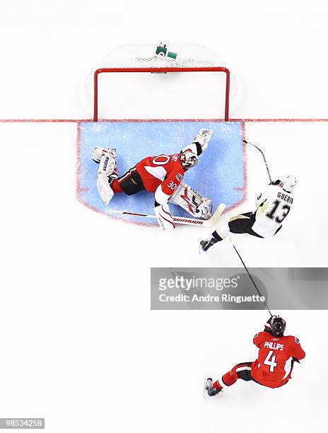 Bill Guerin of the Pittsburgh Penguins shoots the puck past the outstretched glove of Brian Elliott of the Ottawa Senators for a third period goal in...