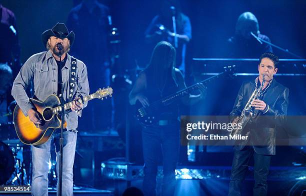 Musicians Toby Keith and Dave Koz perform onstage during the 45th Annual Academy of Country Music Awards at the MGM Grand Garden Arena on April 18,...