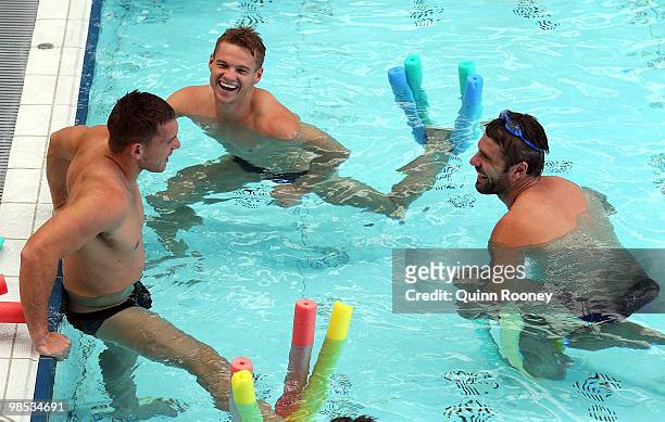 Brent Moloney, Colin Sylvia and Mark Jamar of the Demons relax in the hydrobath pool during a Melbourne Demons AFL recovery session at the Melbourne...