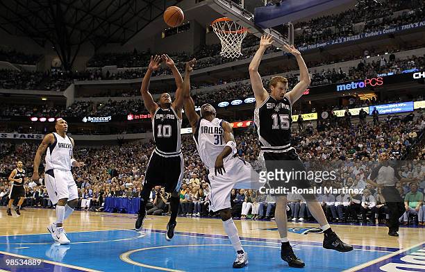 Guard Jason Terry of the Dallas Mavericks takes a shot against Matt Bonner and Keith Bogans of the San Antonio Spurs in Game One of the Western...