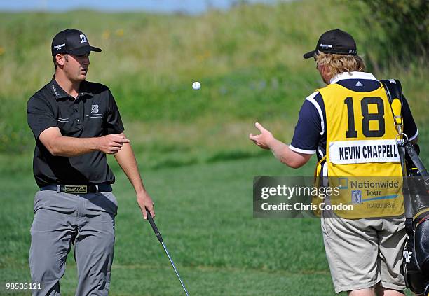 Kevin Chappell tosses his golf ball to his caddie on the 9th green during the final round of the Fresh Express Classic at TPC Stonebrae on April 18,...