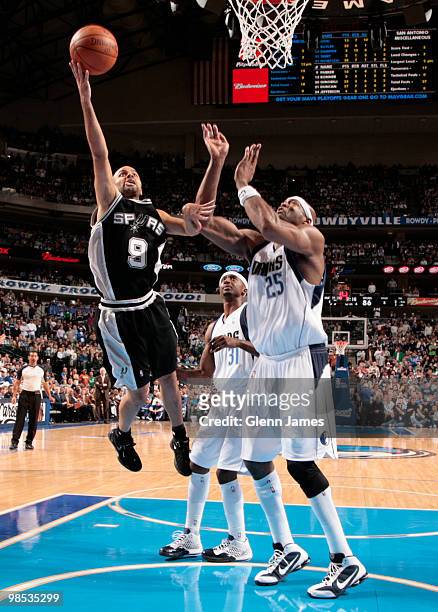 Tony Parker of the San Antonio Spurs goes in for the layup against Erick Dampier and Jason Terry of the Dallas Mavericks in Game One of the Western...