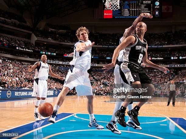 Tony Parker of the San Antonio Spurs makes a pass to a teammate against Dirk Nowitzki and Erick Dampier of the Dallas Mavericks in Game One of the...