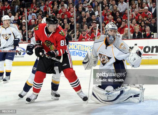 Goalie Pekka Rinne of the Nashville Predators catches the puck as Tomas Kopecky of the Chicago Blackhawks waits in position in front, at Game Two of...