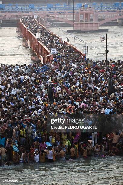 India-religion-festival,FEATURE by Ben Sheppard Hindu devotees arrive at the banks of river Ganges at the Kumbh Mela festival in Haridwar on April...