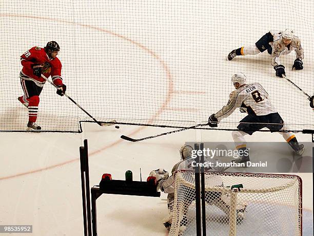 Patrick Kane of the Chicago Blackhawks fires the puck to score a goal against Dan Hamhuis, Kevin Klein and Pekka Rinne of the Nashville Predators in...