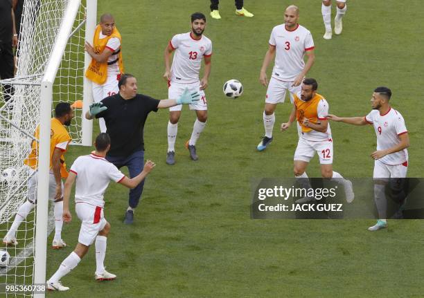 Tunisia's coach Nabil Maaloul trains as a goalkeeper with Tunisia's midfielder Ferjani Sassi , Tunisia's defender Yohan Benalouane , Tunisia's...