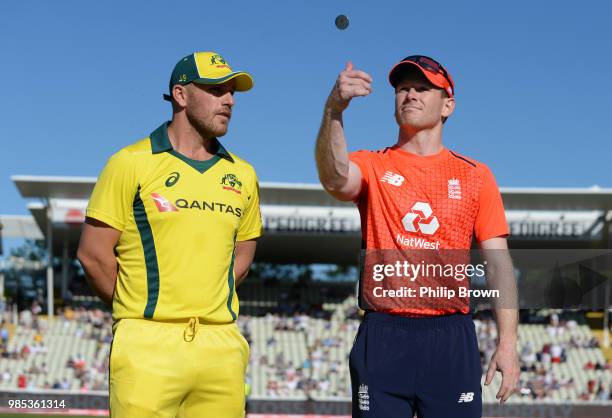 Eoin Morgan of England tosses the coin watched by Aaron Finch of Australia before the 1st NatWest T20 International cricket match between England and...