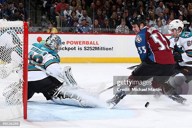 Cody McLeod of the Colorado Avalanche skates the puck into the crease against goaltender Evgeni Nabokov of the San Jose Sharks in game Three of the...