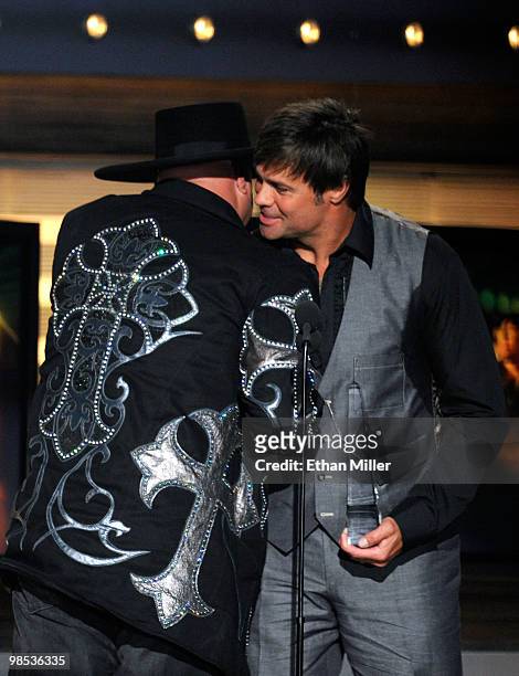 Musicians Eddie Montgomery and Troy Gentry accept the Home Depot Humanitarian award onstage during the 45th Annual Academy of Country Music Awards at...