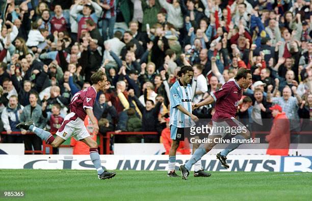 Aston Villa's Paul Merson celebrates the third goal as Coventry's Moustapha Hadji looks on in dispair during the FA Carling Premier League game...