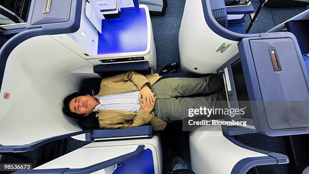 Member of the media inspects the business class cabin of a Boeing 777-300ER passenger jet for All Nippon Airways Co. During its unveiling at Narita...