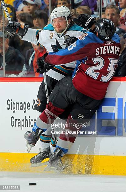 Chris Stewart of the Colorado Avalanche collides on the boards with Douglas Murray of the San Jose Sharks in Game Three of the Western Conference...