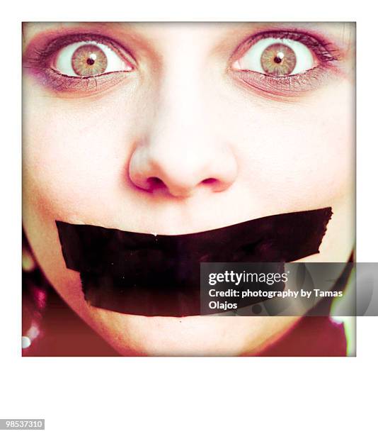 scared girl with plastered mouth - transferbild stock-fotos und bilder