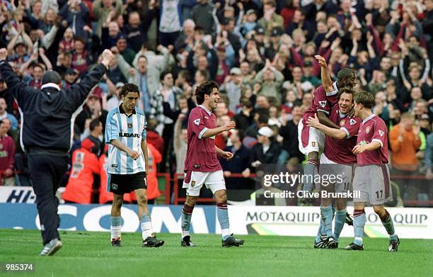 Paul Merson of Villa celebrates scoring the third goal as Coventry's Moustapha Hadji looks on during the FA Carling Premier League game between Aston...