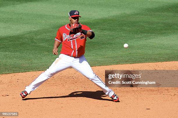 Yunel Escobar of the Atlanta Braves fields a grounder against the Colorado Rockies at Turner Field on April 18, 2010 in Atlanta, Georgia. The Braves...