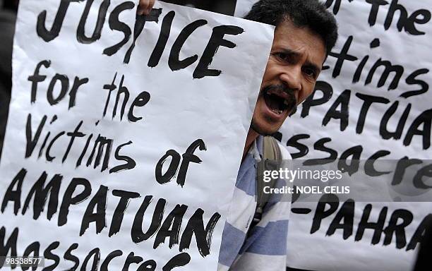 Demonstator attends a protest demanding justice for 57 Amputuan massacre victims in Maguindanao, during a rally in front of the Department of Justice...