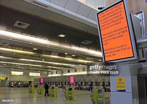 An electronic board advising passengers of flight disruptions due to volcanic ash is pictured in a empty departure lounge at Manchester Airport in...