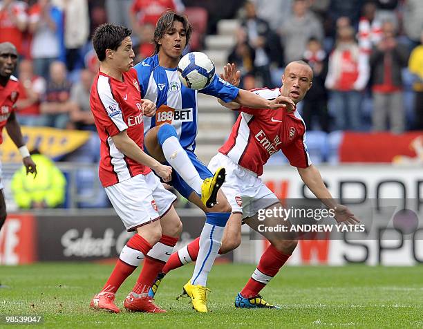 Wigan Athletic's Bolivian midfielder Marcelo Moreno vies with Arsenal's French midfielder Samir Nasri and Arsenal's French defender Mikael Silvestre...
