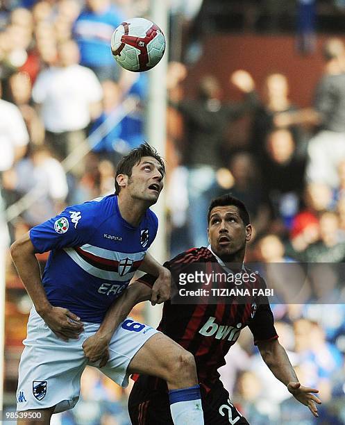 Milan forward Marco Borriello jumps for the ball with Sampdoria's defender Stefano Lucchini during their Italian Serie A football match on April 18,...