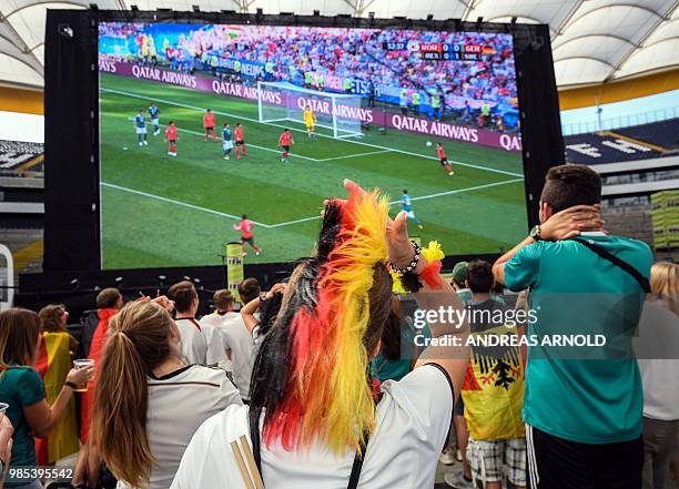 Supporters of the German national football team react as they attend a public viewing event at the Commerzbank Arena stadium in Frankfurt am Main,...