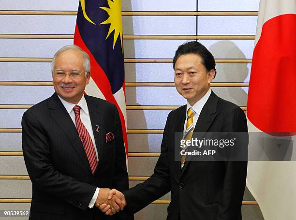 Malaysia's Prime Minister Najib Razak shakes hands with Japanese Prime Minister Yukio Hatoyama at Hatoyama's official residence in Tokyo on April 19,...