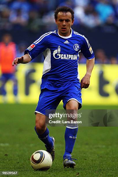 Rafinha of Schalke runs with the ball during the Bundesliga match between FC Schalke 04 and Borussia Moenchengladbach at Veltins Arena on April 17 in...