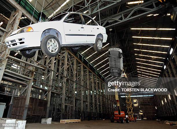 Engineers rig up eight dangling cars for Chinese artist Cai Guo-Qiang's Biennale installation 'Inopportune: Stage One' on Cockatoo Island in Sydney...